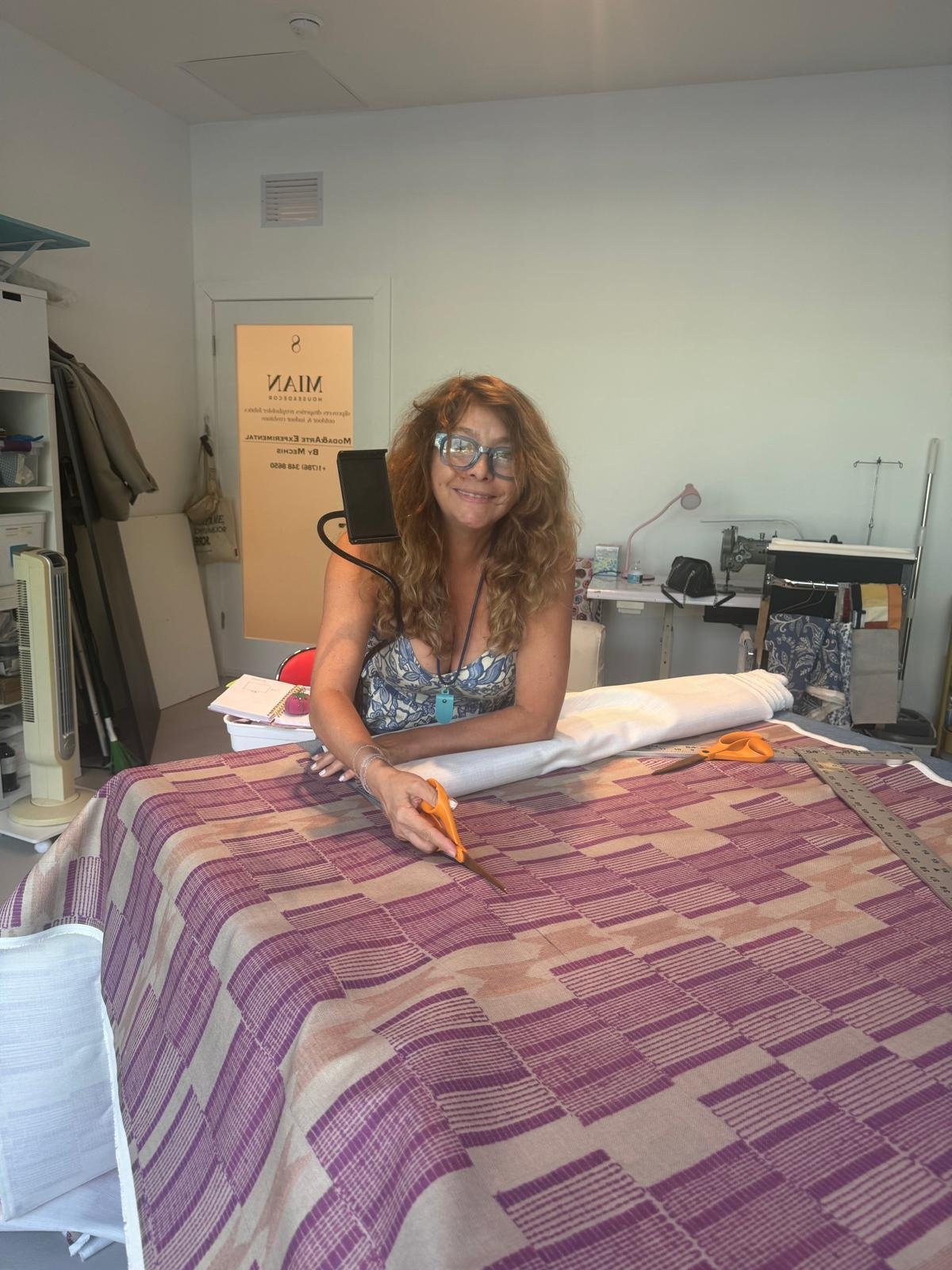 Mercedes Ruiz cutting fabric in the MIAN workshop in Miami